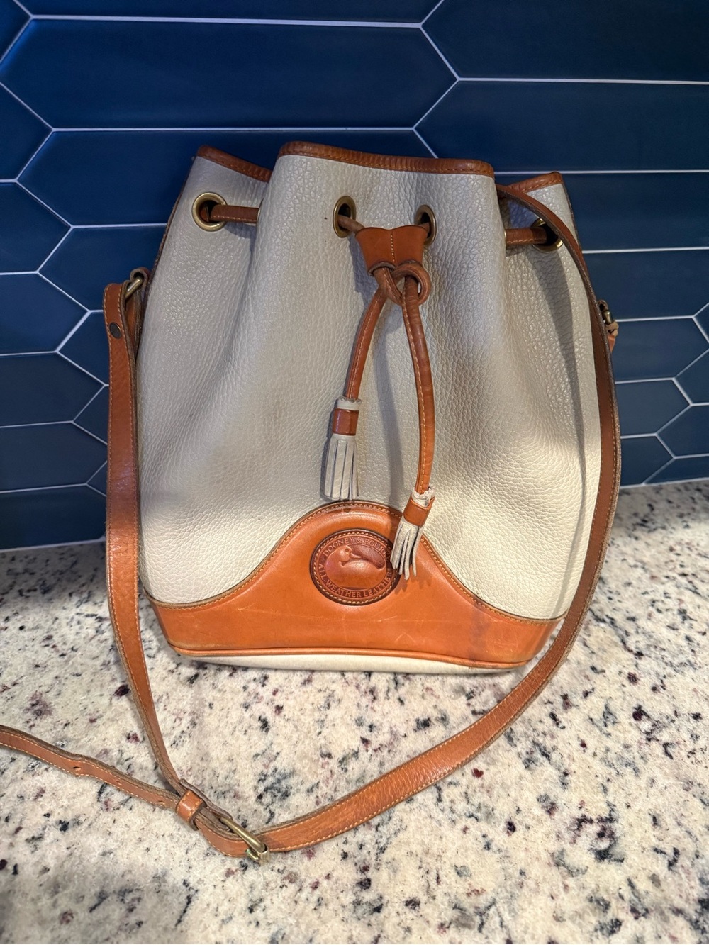 Dooney & Bourke Cream Leather Drawstring Bucket Bag with Brown Trim